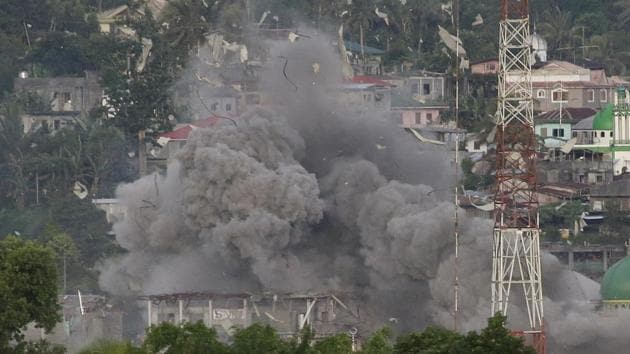 In this file photo from June 9, 2017, a cloud of debris is seen as Philippine Air Force fighter jets bomb suspected positions of Muslim militants as fighting continues in Marawi City in southern Philippines. A year ago, President Rodrigo Duterte promised to cleanse his Southeast Asian nation of illegal drugs in three to six months and tame corruption. Drugs and corruption have persisted and martial law has been extended in the siege in the south by pro-Islamic State militants. (AP) In this file photo from June 9, 2017, a cloud of debris is seen as Philippine Air Force fighter jets bomb suspected positions of Muslim militants as fighting continues in Marawi City in southern Philippines. A year ago, President Rodrigo Duterte promised to cleanse his Southeast Asian nation of illegal drugs in three to six months and tame corruption. Drugs and corruption have persisted and martial law has been extended in the siege in the south by pro-Islamic State militants. (AP)