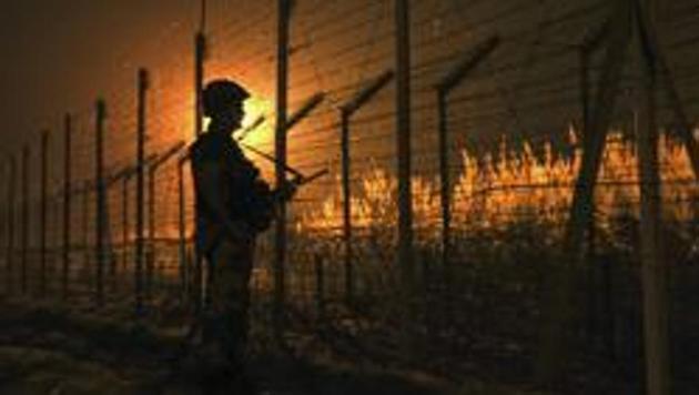 A soldier stands guard near the fence at the India-Pakistan International Border. (HT file) A soldier stands guard near the fence at the India-Pakistan International Border. (HT file)