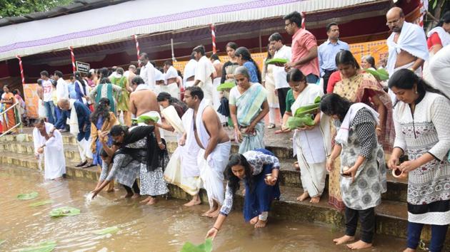 Devotees make their last offerings for their loved ones by finishing the Pithru Tharpanam (Amavasya Shraddha) and flowing it on the river. (HT PHOTO) Devotees make their last offerings for their loved ones by finishing the Pithru Tharpanam (Amavasya Shraddha) and flowing it on the river. (HT PHOTO)