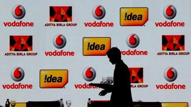 A hotel employee clears a table after Vodafone Group and Idea Cellular news conference in Mumbai.(Reuters file)