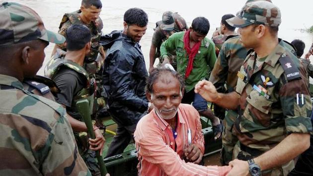 Army personnel rescue villagers, stuck in the flooded villages due to heavy downpour at Surendranagar district, in Gujarat. (PTI) Army personnel rescue villagers, stuck in the flooded villages due to heavy downpour at Surendranagar district, in Gujarat. (PTI)