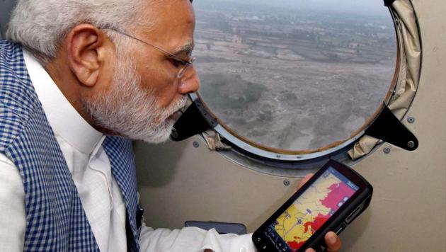 Prime Minister Narendra Modi conducting an aerial survey of flood affected areas of Banaskatha districts of Gujarat on Tuesday.(PTI Photo)