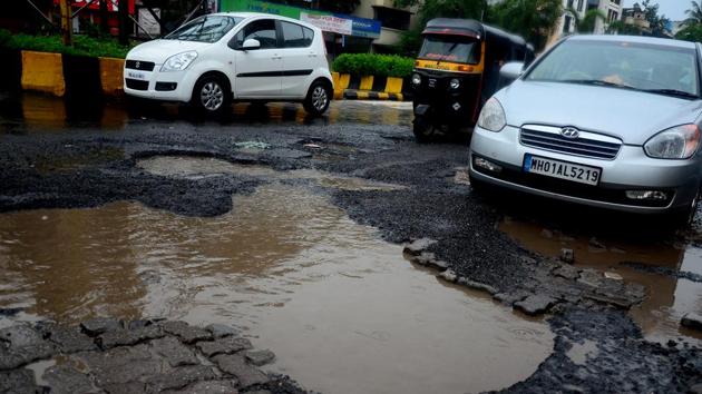 Potholes in a Mumbai road. Elected representatives and public servants should not be allowed to hide behind outdated laws and must be held accountable for their misdeeds(Bachchan Kumar/HT)