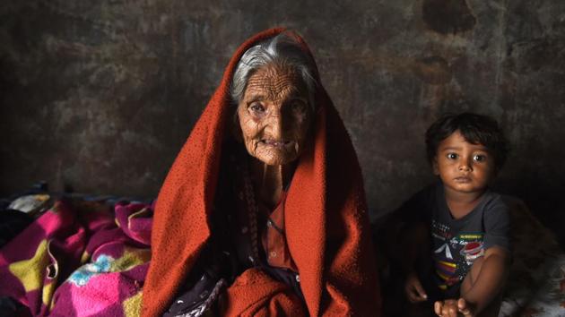Bachiben Katia,105 year old, looks on as the family takes refuge in a railway compartment of a goods train after floods. (SAM PANTHAKY / AFP) Bachiben Katia,105 year old, looks on as the family takes refuge in a railway compartment of a goods train after floods. (SAM PANTHAKY / AFP)