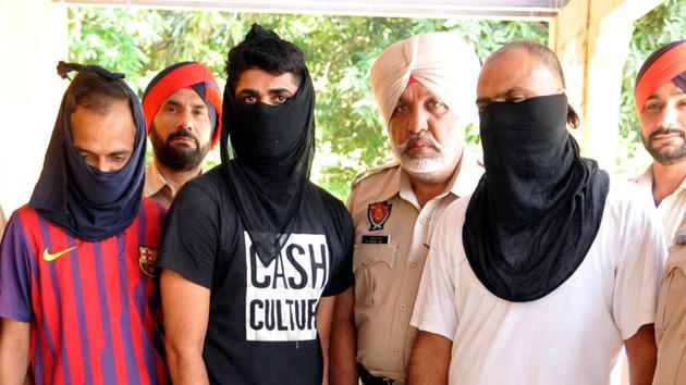 Police officials presenting the arrested members of the inter-state gang of ATM looters in Jalandhar on Tuesday, July 25.(Pardeep Pandit/HT)