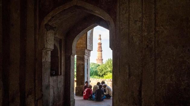 A view of a city landmark -- the Qutub Minar -- from one of the mausoleum’s archways. Like many of the city’s medieval monuments, Adham Khan’s mausoleum stands with its original intent and identity replaced by a newer, colloquial one in the minds of most locals and visitors, much like the ever changing city of Delhi. (Abhirup Biswas / HT Photo)