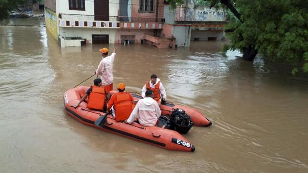Flood waters swept across several places in the country today, killing two in Rajasthan and forcing Gujarat to declare a high alert. (PTI) Flood waters swept across several places in the country today, killing two in Rajasthan and forcing Gujarat to declare a high alert. (PTI)