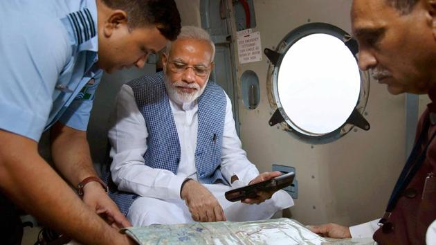 Prime Minister Narendra Modi with Gujarat chief minister Vijay Rupani during an aerial survey of flood-affected areas of Banaskatha district of Gujarat on Tuesday.(PTI Photo)