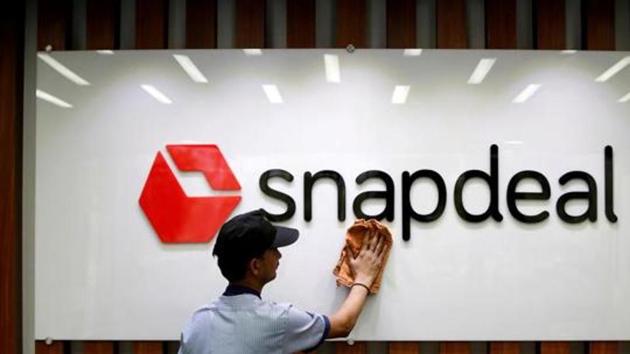 An employee cleans a Snapdeal logo at its headquarters in Gurugram. (Reuters File Photo) An employee cleans a Snapdeal logo at its headquarters in Gurugram. (Reuters File Photo)