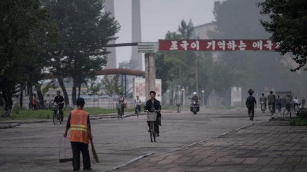 A photo taken on July 22, 2017 shows workers passing along a road at the Chollima Steel Complex, south-west of Pyongyang. (AFP Photo)