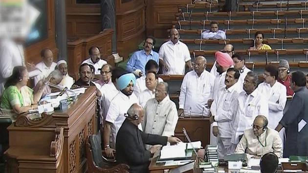 Opposition members protest in the well of the Lok Sabha in New Delhi on Wednesday.(PTI)