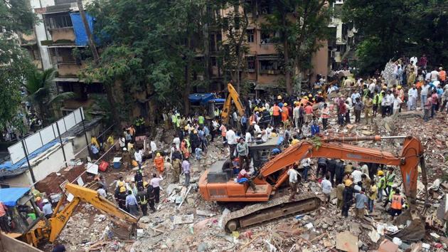Fire brigade and NDRF personnel carrying out a search and rescue operation following a building collapse at Ghatkopar in Mumbai on Tuesday. (PTI Photo) Fire brigade and NDRF personnel carrying out a search and rescue operation following a building collapse at Ghatkopar in Mumbai on Tuesday. (PTI Photo)