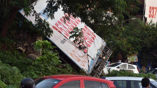 Knocked down hoarding by PMC at riverbed in Pune, India, on Wednesday, July 26, 2017(HT PHOTO)