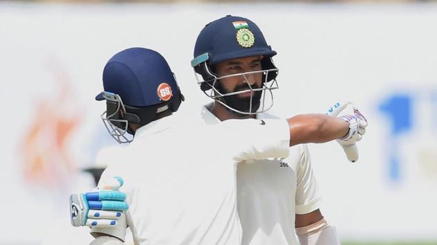 India’s Cheteshwar Pujara (R) celebrates scoring 150 runs with teammate Ajinkya Rahane during Day 2 of the 1st Test vs Sri Lanka at Galle on Thursday. (AFP) India’s Cheteshwar Pujara (R) celebrates scoring 150 runs with teammate Ajinkya Rahane during Day 2 of the 1st Test vs Sri Lanka at Galle on Thursday. (AFP)