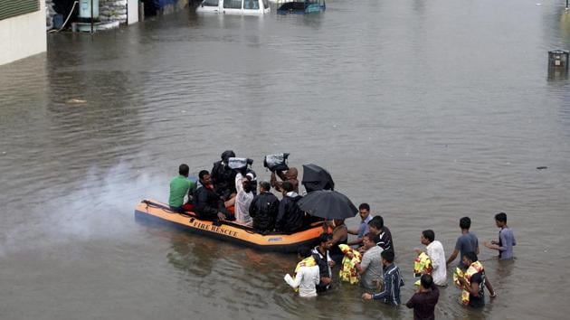 Voluteers carry out relief works in a flooded locality after heavy rains in Ahmedabad on Thursday. (PTI) Voluteers carry out relief works in a flooded locality after heavy rains in Ahmedabad on Thursday. (PTI)