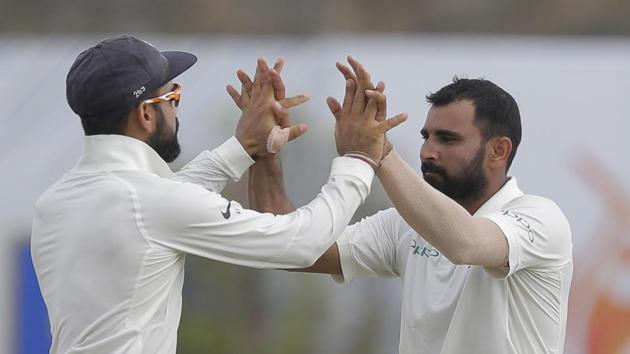 Mohammed Shami and Virat Kohli celebrate the fall of a wicket. Get full cricket score of India vs Sri Lanka, 1st Test, day 2 from Galle here.(AP)