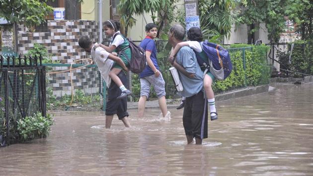 School students getting piggyback ride after streets in sector 19, Panchkula, were flooded after heavy rains lashed in the region on Thursday. (Sant Arora/HT Photo) School students getting piggyback ride after streets in sector 19, Panchkula, were flooded after heavy rains lashed in the region on Thursday. (Sant Arora/HT Photo)