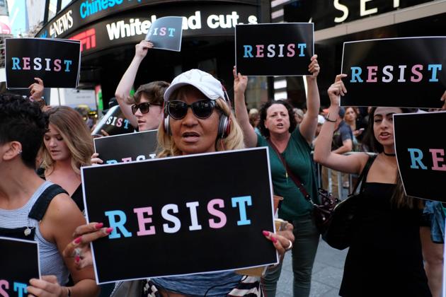 Protesters shout slogans against Donald Trump during a demonstration in front of the US Army career centre in Times Square, New York, on July 26, 2017. (AFP) Protesters shout slogans against Donald Trump during a demonstration in front of the US Army career centre in Times Square, New York, on July 26, 2017. (AFP)