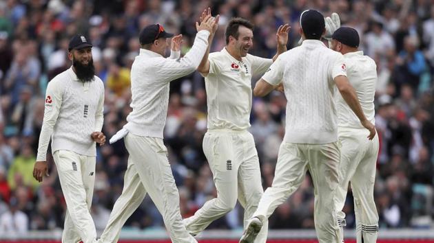England's Toby Roland-Jones, centre, celebrates with his team after taking the wicket of South Africa's Hashim Amla on the second day of the third Test. (AP) England's Toby Roland-Jones, centre, celebrates with his team after taking the wicket of South Africa's Hashim Amla on the second day of the third Test. (AP)