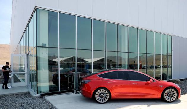 File photo of a prototype of the Tesla Model 3 on display in front of its factory.(REUTERS)