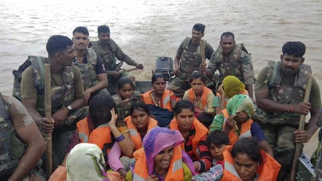India army soldiers rescue flood affected villagers near Shihori in Banaskantha district. (Ajit Solanki / AP)