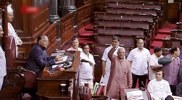 Opposition members protest in the well of Rajya Sabha in New Delhi on Friday.(PTI Photo)