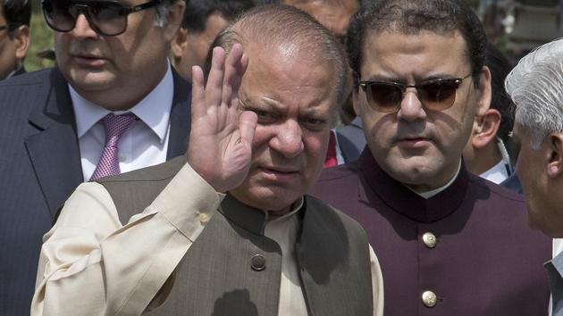Pakistani Prime Minister Nawaz Sharif with his son Hussain Nawaz, right, outside the premises of the Joint Investigation Team, in Islamabad, Pakistan on June 15, 2017.(AP File Photo)