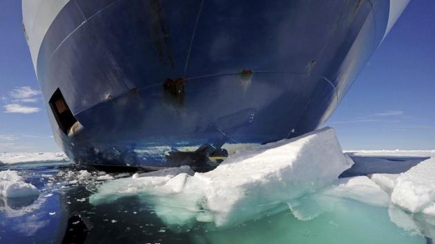 The bow of the icebreaker MSV Nordica pushes down sea ice as it sails through the Victoria Strait. The MSV Nordica is equipped with several heavy-duty engines and a hardened bow and hull that allow it either to drive through thin layers of ice or to crush thicker sheets by rising onto the ice with the help of its rounded hull. The ship's massive weight breaks the ice from above. (David Goldman / AP)