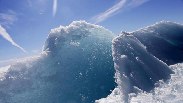 Broken sea ice emerges from under the hull of the Finnish icebreaker MSV Nordica as it sails through the Victoria Strait. As a general rule, the older ice gets the more it turns blue and acquires mounds, so-called hummocks, on top from years of crashing into other ice sheets. (David Goldman / AP)