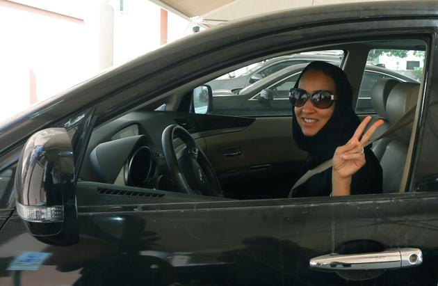 Saudi activist Manal Al Sharif, who now lives in Dubai, flashes the sign for victory as she drives her car in the Gulf Emirate city on October 22, 2013, in solidarity with Saudi women preparing to take to the wheel on October 26, defying the Saudi authorities, to campaign women's right to drive in Saudi Arabia. (AFP File Photo) Saudi activist Manal Al Sharif, who now lives in Dubai, flashes the sign for victory as she drives her car in the Gulf Emirate city on October 22, 2013, in solidarity with Saudi women preparing to take to the wheel on October 26, defying the Saudi authorities, to campaign women's right to drive in Saudi Arabia. (AFP File Photo)