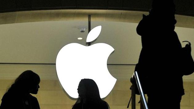 People walk past the Apple logo at the Apple Store at Grand Central Terminal in New York.(AFP File Photo)