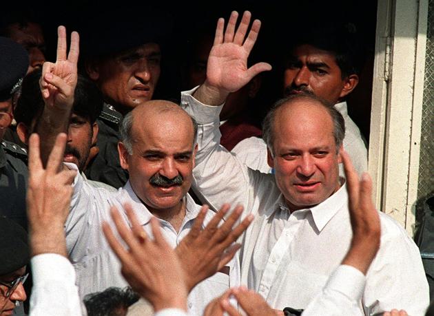Nawaz Sharif (R) and younger brother Shahbaz Sharif wave at supporters in Karachi on December 4, 1999, after the coup by then army chief Pervez Musharraf.(AFP)