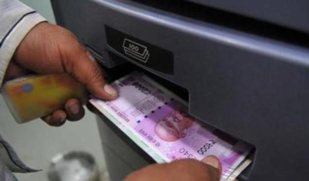 A man takes out a Rs 2,000 currency note from an ATM. (HT File Photo) A man takes out a Rs 2,000 currency note from an ATM. (HT File Photo)