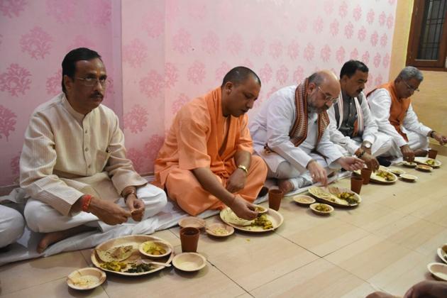 BJP chief Amit Shah and Uttar Pradesh chief minister Yogi Adityanath at lunch at the residence of a booth level worker of the party in Lucknow. (HT Photo) BJP chief Amit Shah and Uttar Pradesh chief minister Yogi Adityanath at lunch at the residence of a booth level worker of the party in Lucknow. (HT Photo)