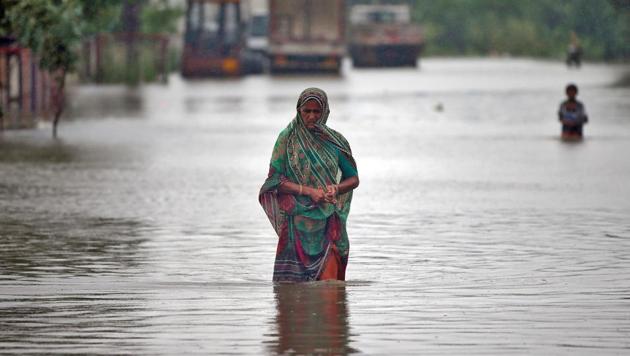 A woman wades through a road flooded by heavy rain in Ahmedabad on July 24. (REUTERS/Amit Dave) A woman wades through a road flooded by heavy rain in Ahmedabad on July 24. (REUTERS/Amit Dave)