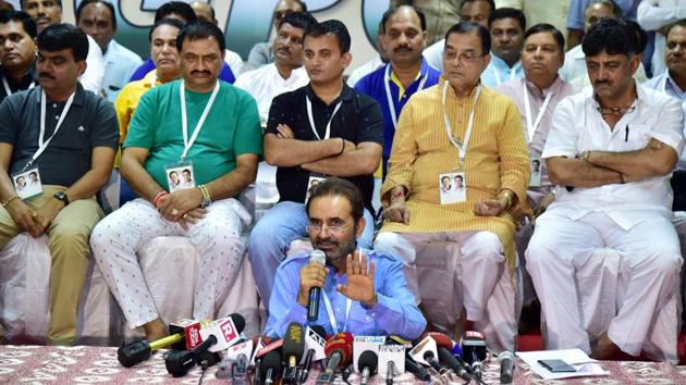 Congress spokesperson Shaktisinh Gohil speaks as Gujarat Congress MLAs are seated behind him during a press conference at a resort on the outskirts of Bengaluru on Sunday.(PTI Photo)