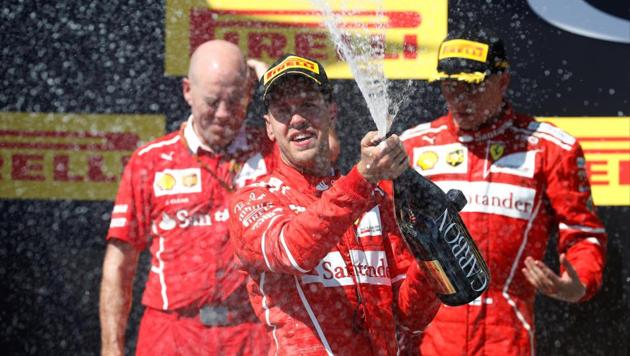 Ferrari's Sebastian Vettel celebrates winning the Hungarian Grand Prix on the podium by spraying sparkling wine in Budapest on Sunday. (Reuters) Ferrari's Sebastian Vettel celebrates winning the Hungarian Grand Prix on the podium by spraying sparkling wine in Budapest on Sunday. (Reuters)