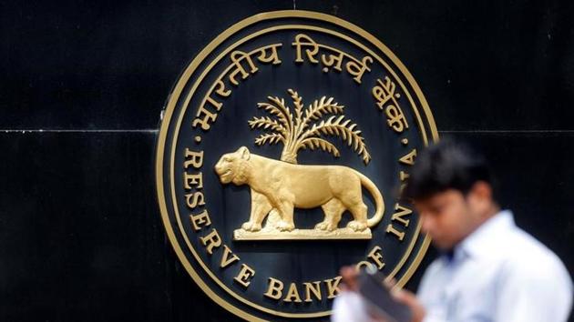 A man checks his phone outside the Reserve Bank of India headquarters in Mumbai. (Reuters) A man checks his phone outside the Reserve Bank of India headquarters in Mumbai. (Reuters)