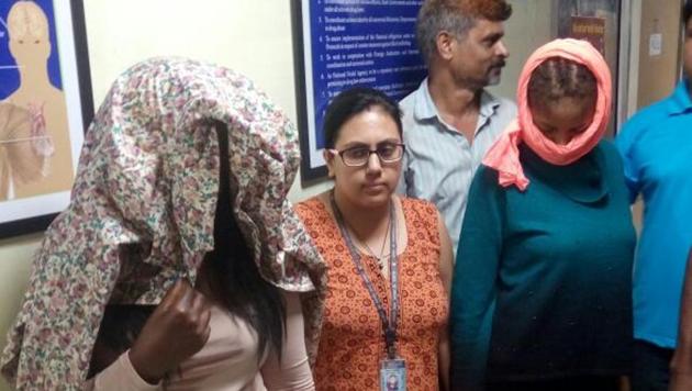 Two of the accused (faces covered) who were nabbed from IGI Airport. (Sourced) Two of the accused (faces covered) who were nabbed from IGI Airport. (Sourced)