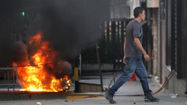 A man walks past a burning barricade after clashes broke out while the Constituent Assembly election was being carried out in Caracas, Venezuela, on July 30. (REUTERS) A man walks past a burning barricade after clashes broke out while the Constituent Assembly election was being carried out in Caracas, Venezuela, on July 30. (REUTERS)