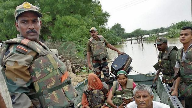 Army rescue team evacuated 3 women, 2 of them were pregnant and one months baby during flood at Shivpura village in Jalore, Rajasthan on Sunday. (PTI Photo) Army rescue team evacuated 3 women, 2 of them were pregnant and one months baby during flood at Shivpura village in Jalore, Rajasthan on Sunday. (PTI Photo)