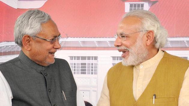 A file photo of Prime Minister Narendra Modi with Bihar chief minister Nitish Kumar at programme in Patna. Opposition parties are criticising Bihar chief minister Nitish Kumar for resigning and taking oath again in less than 24 hours.(AP Dube/HT File Photo)