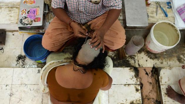 An Indian Hindu devotee gets her head shaved at the Thiruthani Murugan Temple in Thiruthani, Tamil Nadu. One legend has it that the Hindu preserver god Vishnu took out a loan for his wedding and found the sum so large that his devotees have been aiding the repayment of that debt with the only offering they have - -the hair from their heads. (Arun Sankar / AFP) An Indian Hindu devotee gets her head shaved at the Thiruthani Murugan Temple in Thiruthani, Tamil Nadu. One legend has it that the Hindu preserver god Vishnu took out a loan for his wedding and found the sum so large that his devotees have been aiding the repayment of that debt with the only offering they have - -the hair from their heads. (Arun Sankar / AFP)