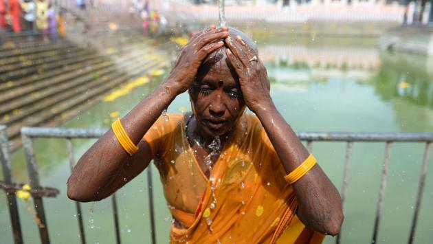 A devotee takes a shower after getting her head shaved at the Thiruthani Murugan Temple. The hair donated at such temples eventually finds its way into the markets of Europe, Asia, the United States as well as parts of Africa in the form of hair extension and replacement products. (Arun Sankar / AFP) A devotee takes a shower after getting her head shaved at the Thiruthani Murugan Temple. The hair donated at such temples eventually finds its way into the markets of Europe, Asia, the United States as well as parts of Africa in the form of hair extension and replacement products. (Arun Sankar / AFP)