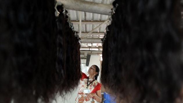 A worker hangs human hair to dry after being washed at a hair collection firm’s processing centre in Alinjivakkam, Chennai. Once collected by the temples, attendants sort the hair on the basis of length and quality, which is then auctioned off to various processing plants. (Arun Sankar / AFP) A worker hangs human hair to dry after being washed at a hair collection firm’s processing centre in Alinjivakkam, Chennai. Once collected by the temples, attendants sort the hair on the basis of length and quality, which is then auctioned off to various processing plants. (Arun Sankar / AFP)