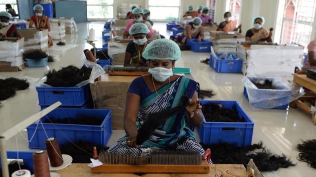 Workers at one of the hair processing plants sort and segregate hair on the basis of quality and cut. Indian hair is considered more valuable in foreign markets due to its higher quality and a lack of chemical dyes and processing done by the wearer. (Arun Sankar / AFP) Workers at one of the hair processing plants sort and segregate hair on the basis of quality and cut. Indian hair is considered more valuable in foreign markets due to its higher quality and a lack of chemical dyes and processing done by the wearer. (Arun Sankar / AFP)