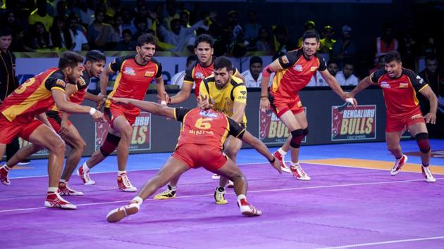 Bengaluru Bulls players pin down Telugu Titans captain Rahul Chaudhari, in yellow, during their Pro Kabaddi League 2017 match. (AP) Bengaluru Bulls players pin down Telugu Titans captain Rahul Chaudhari, in yellow, during their Pro Kabaddi League 2017 match. (AP)