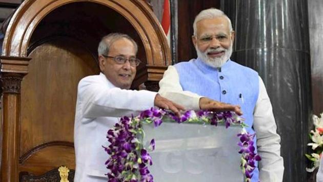 Former President Pranab Mukherjee and Prime Minister Narendra Modi press buttons for the launch of Goods and Services Tax at midnight of June 30 at the special ceremony in the Central Hall of Parliament in New Delhi.(PTI File photo)