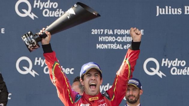 Lucas Di Grassi of Brazil celebrates after being presented with the Formula E driver's championship trophy at the Montreal Formula ePrix electric car race.(AP)