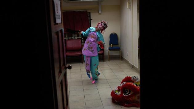 A ten-year old Chinese Cantonese opera actress Yujian Nuo from Beijing rehearses backstage. (MANAN VATSYAYANA / AFP) A ten-year old Chinese Cantonese opera actress Yujian Nuo from Beijing rehearses backstage. (MANAN VATSYAYANA / AFP)
